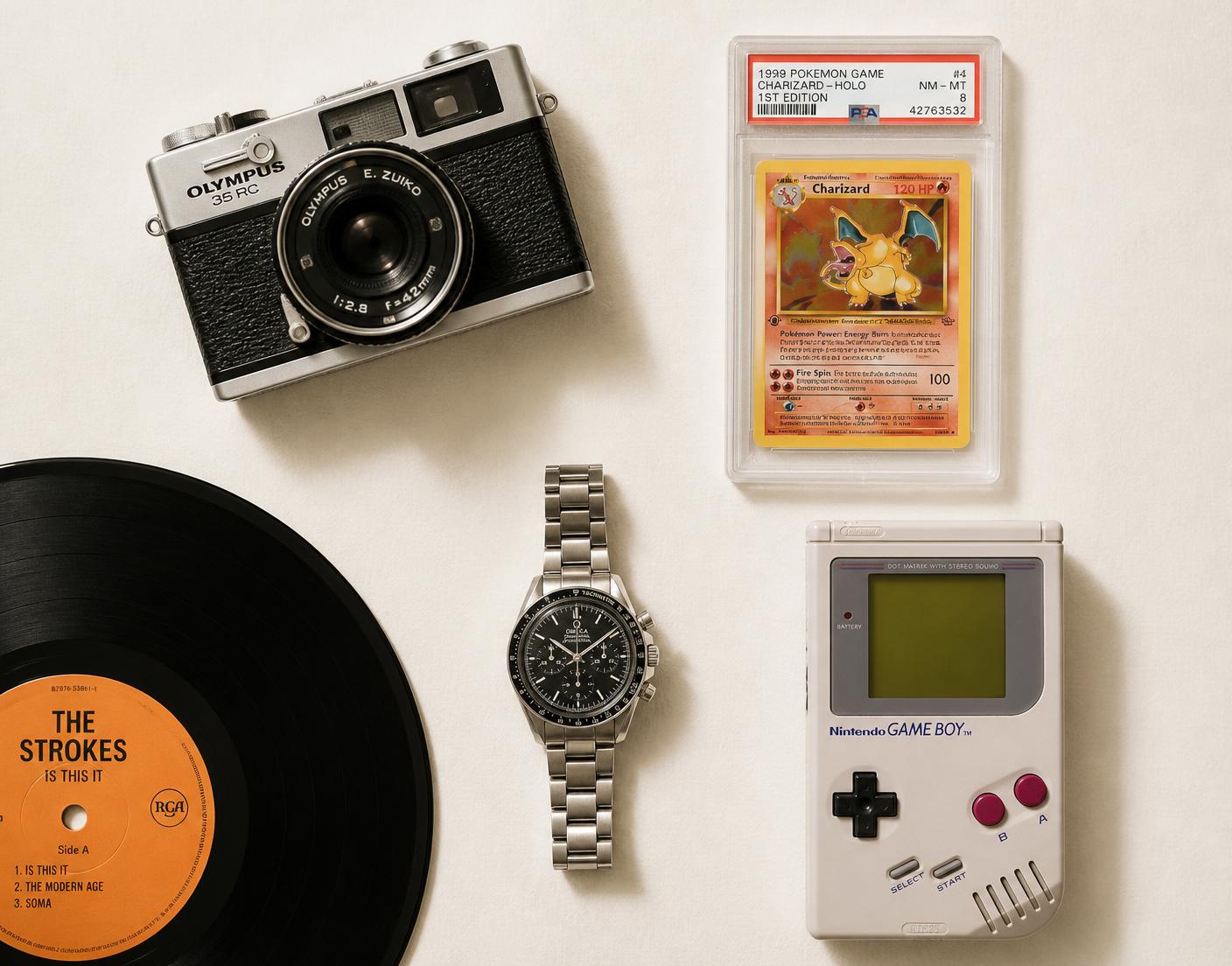 A vintage film camera, graded trading card, handheld console, vinyl record and mechanical watch arranged on a warm off-white surface